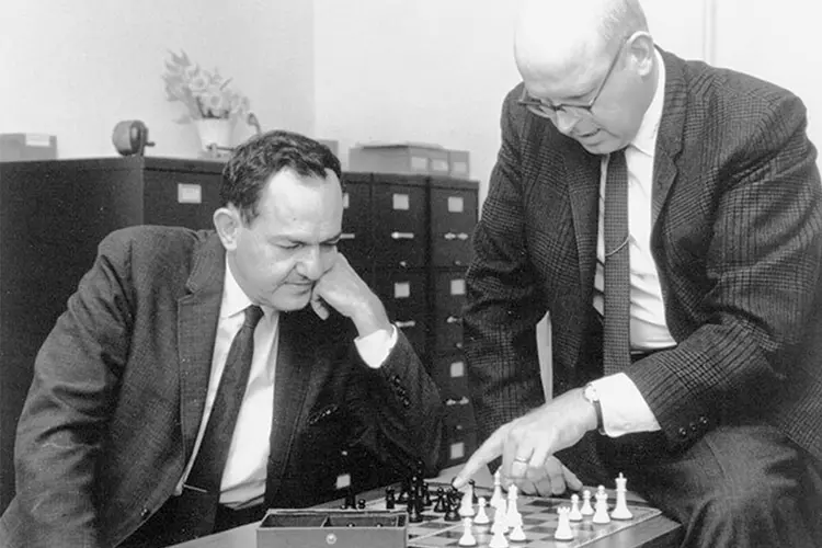 Carnegie Mellon University researchers Allen Newell and Herbert Simon (the founding father of AI) playing chess together as they develop AI and chess software in the 1950s.